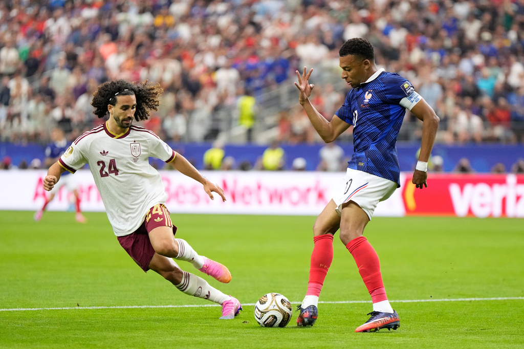 France's Kylian Mbappe passes the ball next to Spain's Marc Cucurella during the World Cup semifinal soccer match between France and Spain in Arlington, Texas, near Dallas, Tuesday, July 14, 2026. (AP Photo/Ashley Landis)