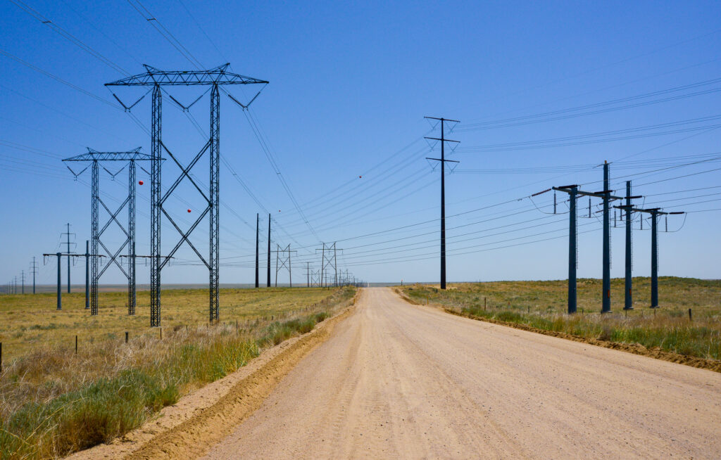 Power lines criss-crossing rural dirt road in Morgan County, Colo.