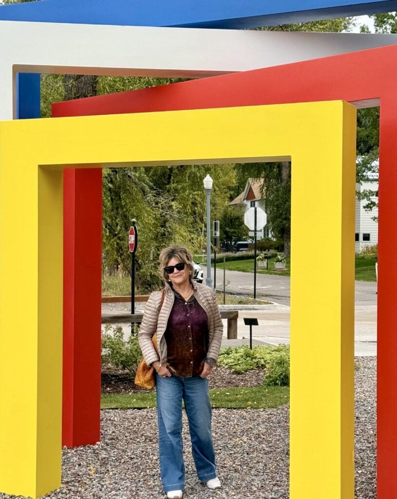 Denver resident Elizabeth Schlosser poses for a picture standing in the Harbert Bayer sculpture in Aspen, Colorado.