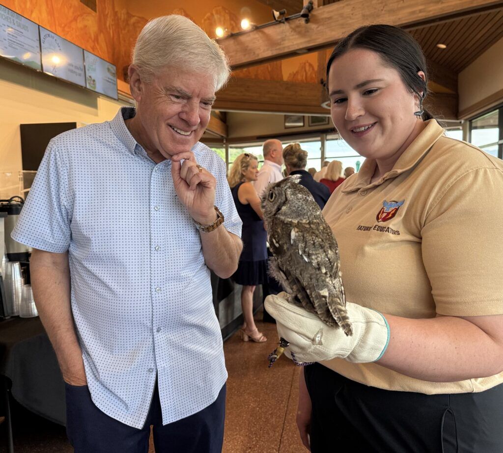 Garden of the Gods Foundation, Doug Price meets Thistle, Eastern Screech Owl, with Nature's Educators' Johni Poggemeyer. Linda Navarro/The Gazette