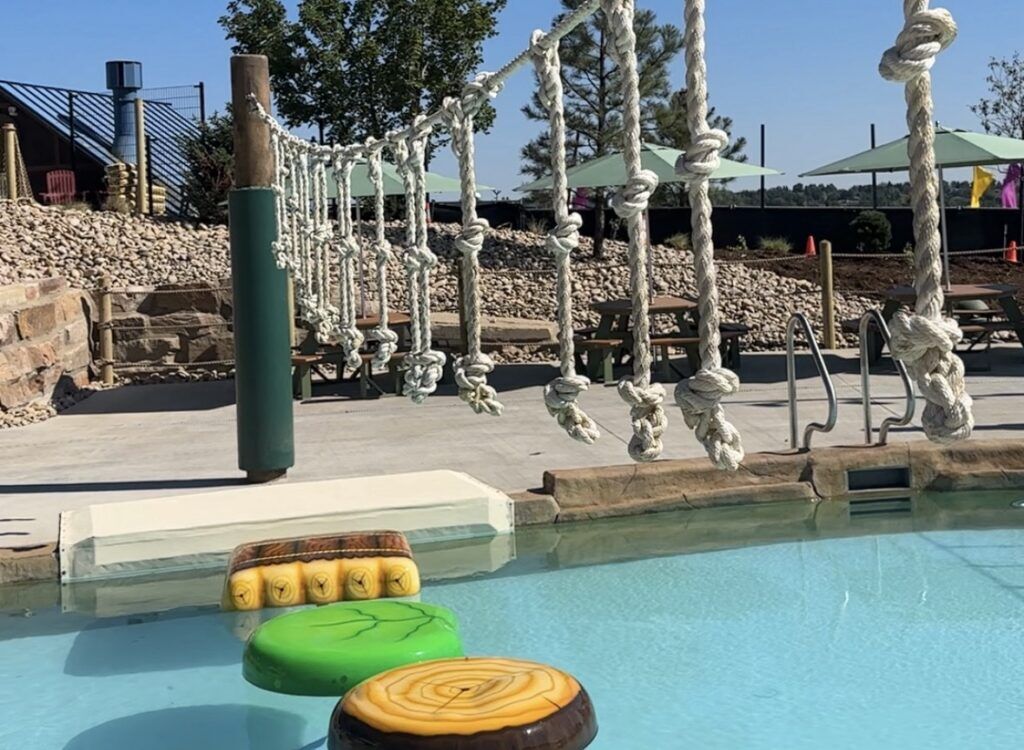 The new 'Creekside Crossing' at Water World's new Summit Canyon features a rope obstacle course with floating logs and lily pads over water. (Emily Bejarano/The Denver Gazette)