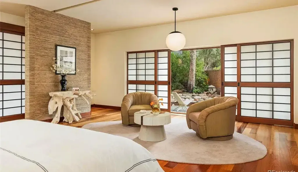 The primary suite is set in an adjoining pavilion, across a covered bridge from the entertaining areas.