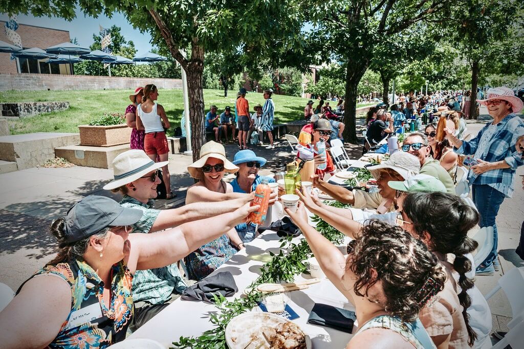 Guests clink cups in a celebratory cheers at The Mile Long Table. (Photo courtesy of Longer Table)