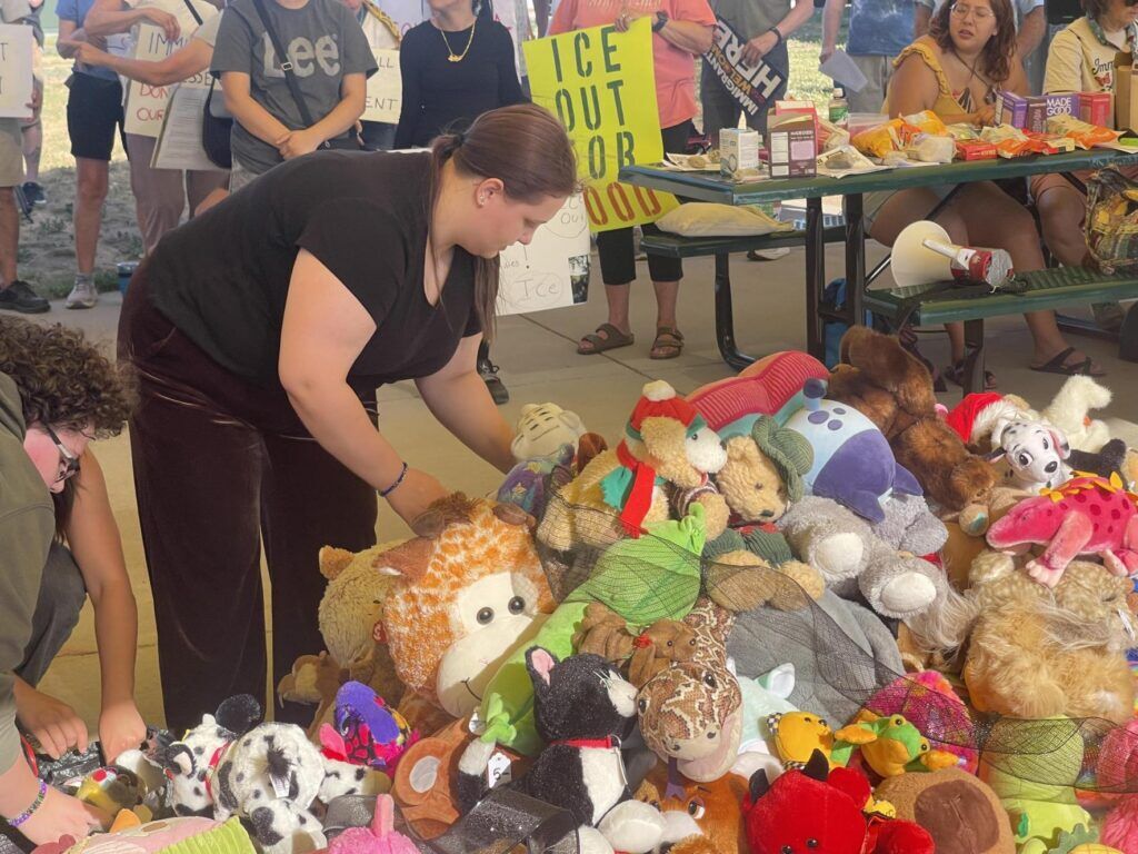 A woman puts stuffed animals on the ground