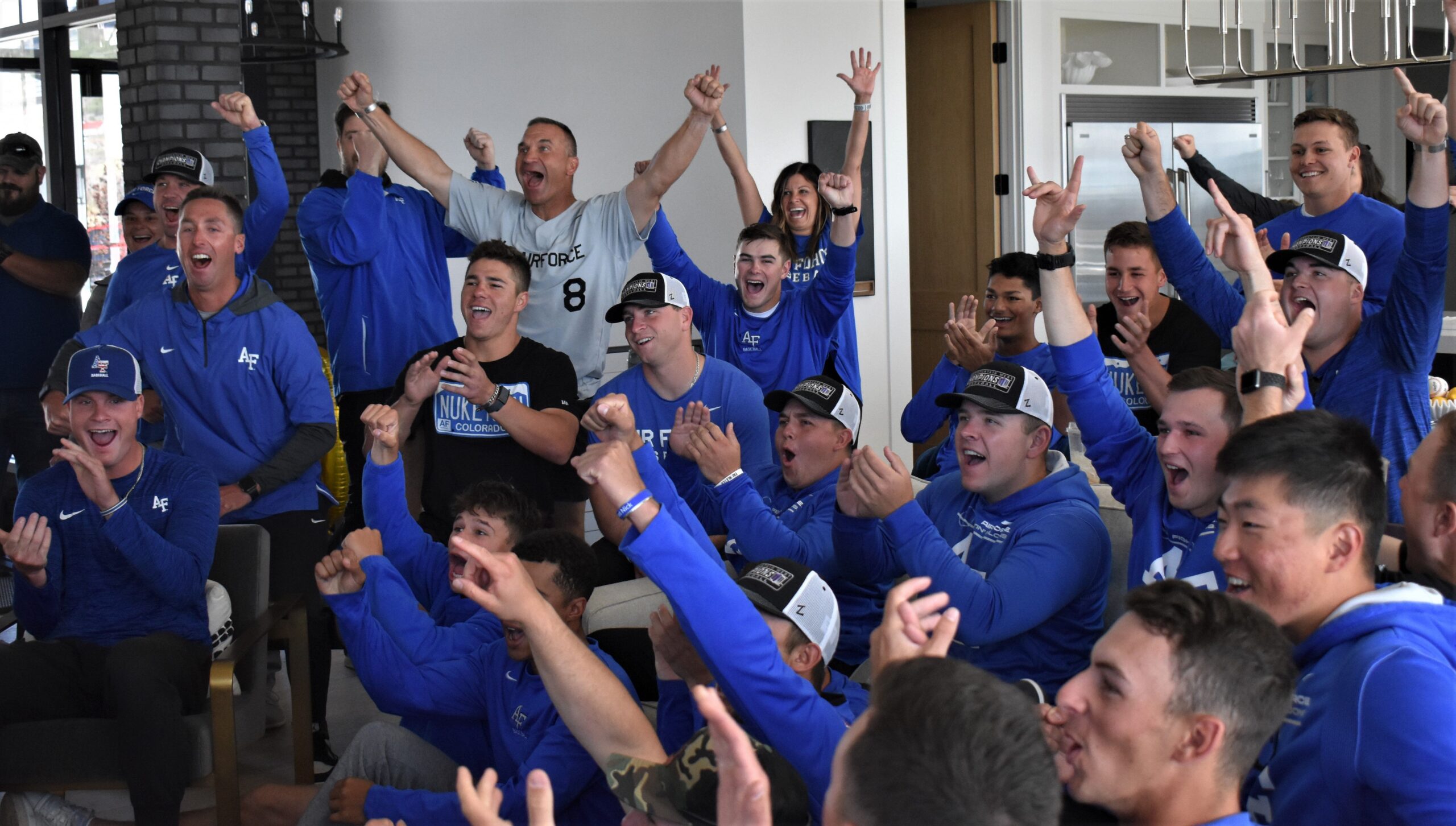 Members of the Air Force baseball team, coaching staff and their families celebrate at coach Mike Kazlausky’s home in Monument as the team’s name appears in an NCAA Regional during the ESPN2 broadcast of the field announcement in 2022. (Brent Briggeman, The Gazette)