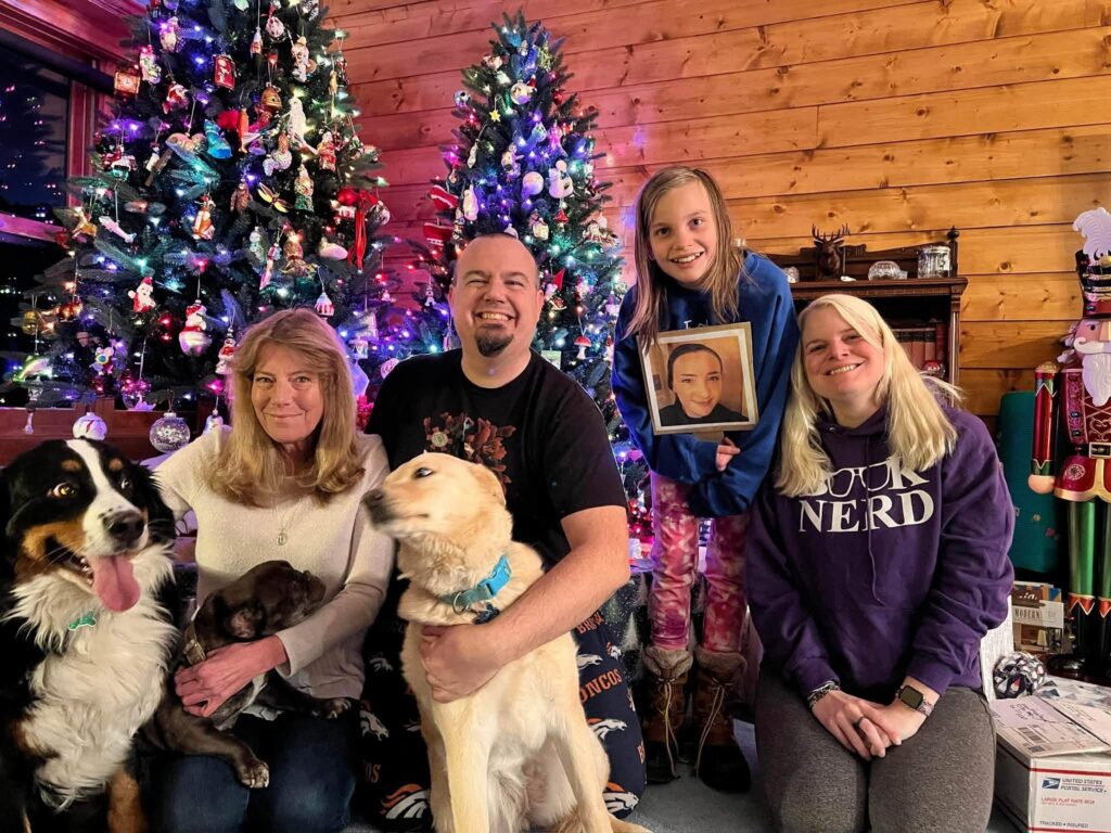 A family is pictured at Christmas with their dogs.