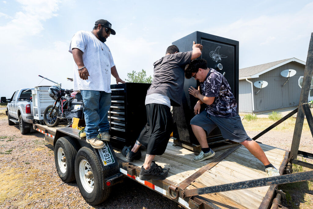Victor Ruschena, center, loads a gun safe onto his trailer with the help of his brother, Valentino Ruschena, left, and friend, Ty Haddock Monday, July 6, 2026, as he evacuates his home in Coal Creek, Colo., because of the Aspen Acres fire. The fire had grown to 91,981.8 acres as of 12:23 p.m. Monday. (The Gazette, Christian Murdock)